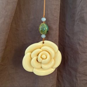 Long, Ivory resin necklace with beads.